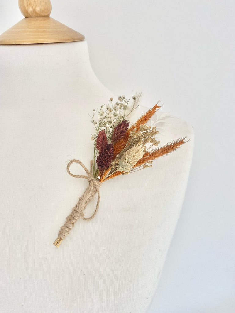 Burnt Orange Range Buttonhole with dried Orange Pinion Grass, Phalaris, and Gypsophila in rustic autumn tones