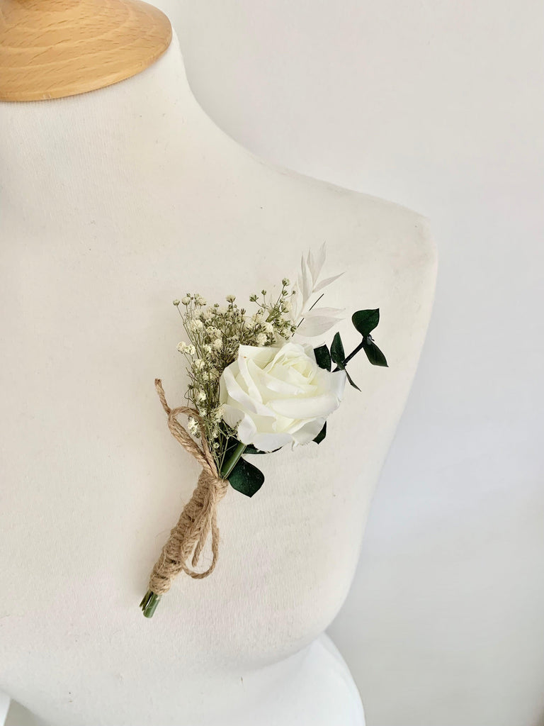 Elegance Range buttonhole with silk rose, white ruscus, green eucalyptus, and gypsophila – classic wedding accessory, long-lasting and low-maintenance.