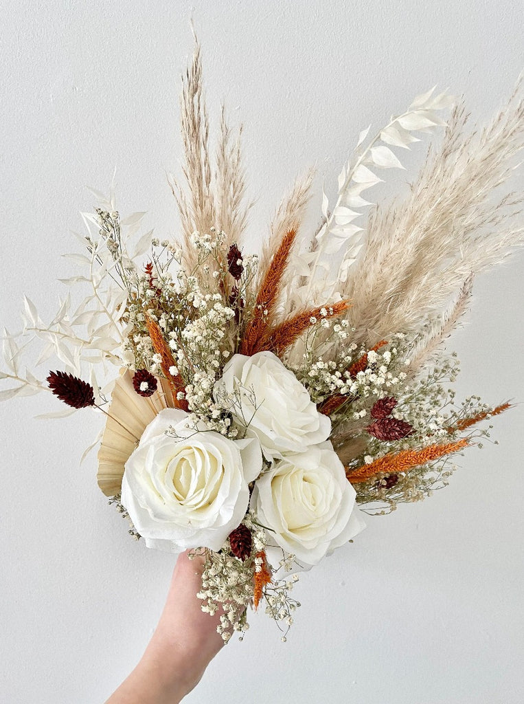 Autumn wedding bridesmaid bouquet featuring burnt orange and earthy tones, pampas, palms, and ruscus