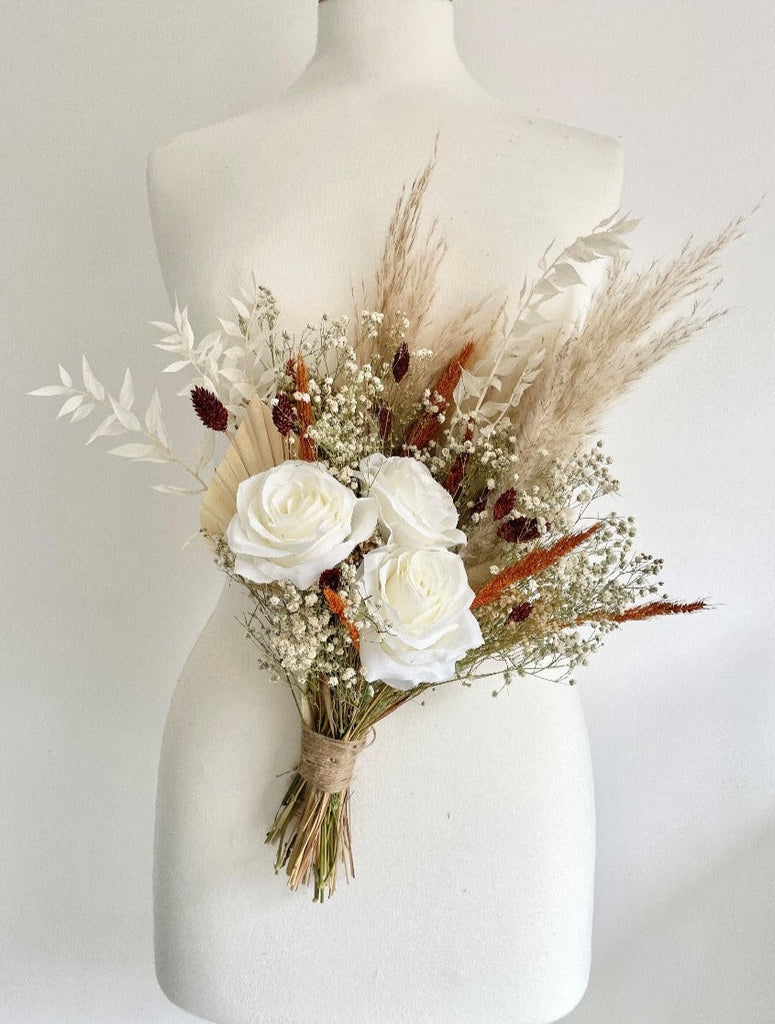 Burnt Orange Range Bridesmaid Bouquet featuring faux silk roses, orange pinion grass, brown phalaris, pampas, palms, ruscus and gypsophila, autumn wedding bouquet