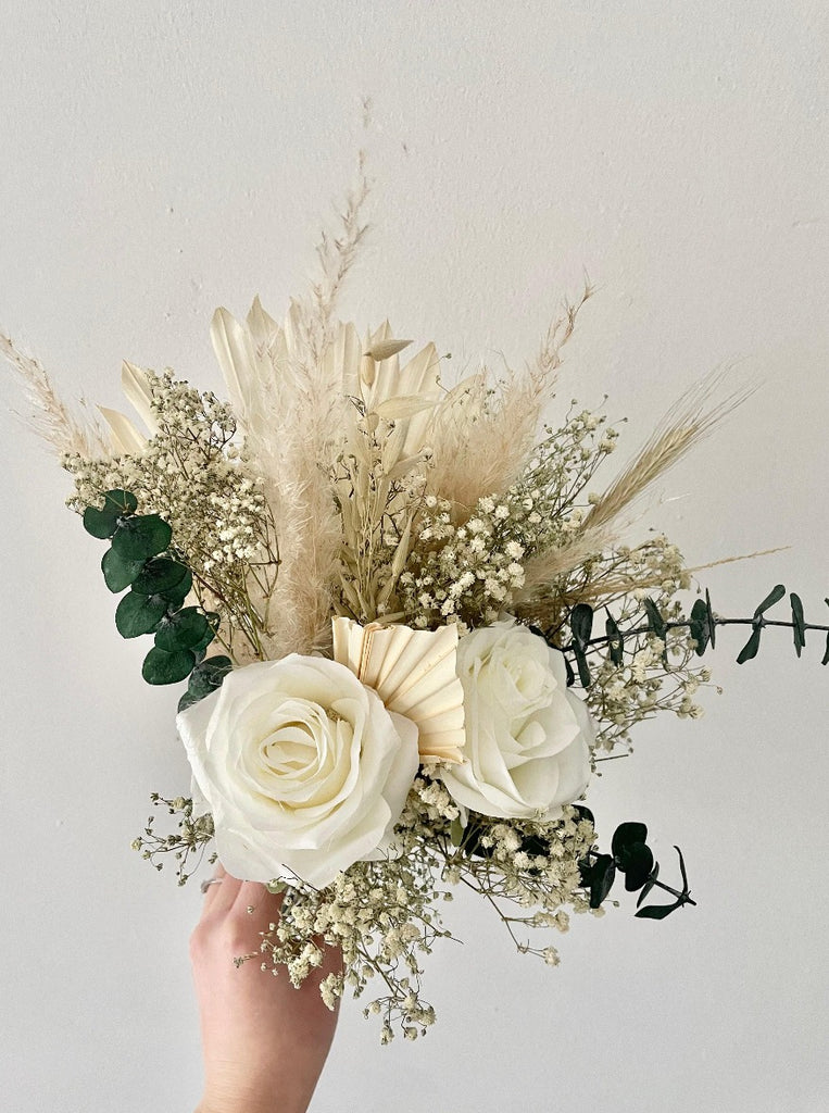Close-up of faux silk roses, gypsophila and pampas in bridesmaid bouquet